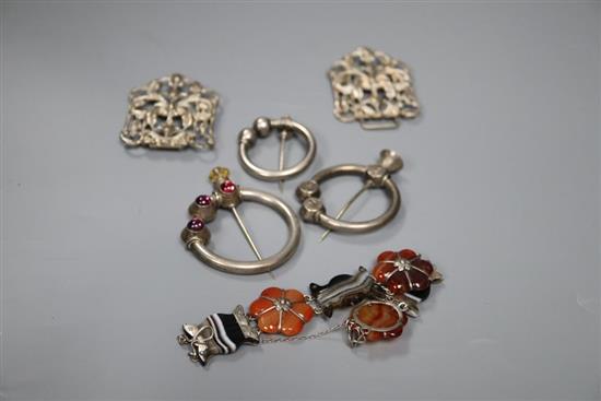 Three Scottish white metal torqs, a silver buckle and a white metal and Scottish hardstone set bracelet.